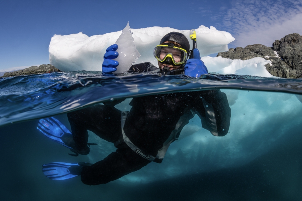 snorkeler holding ice block